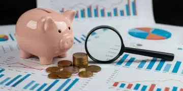 Financial charts with piggy bank and magnifying glass, symbolizing retirement savings protection against 2025 inflation.