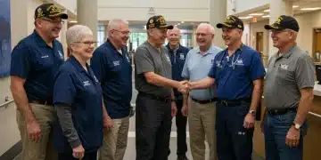 Veterans smiling with VA staff in a modern healthcare facility, symbolizing expanded care.