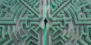 An aerial view of a person confidently walking on a glowing green path through a complex, frosted glass labyrinth, symbolizing clear navigation through benefit systems.